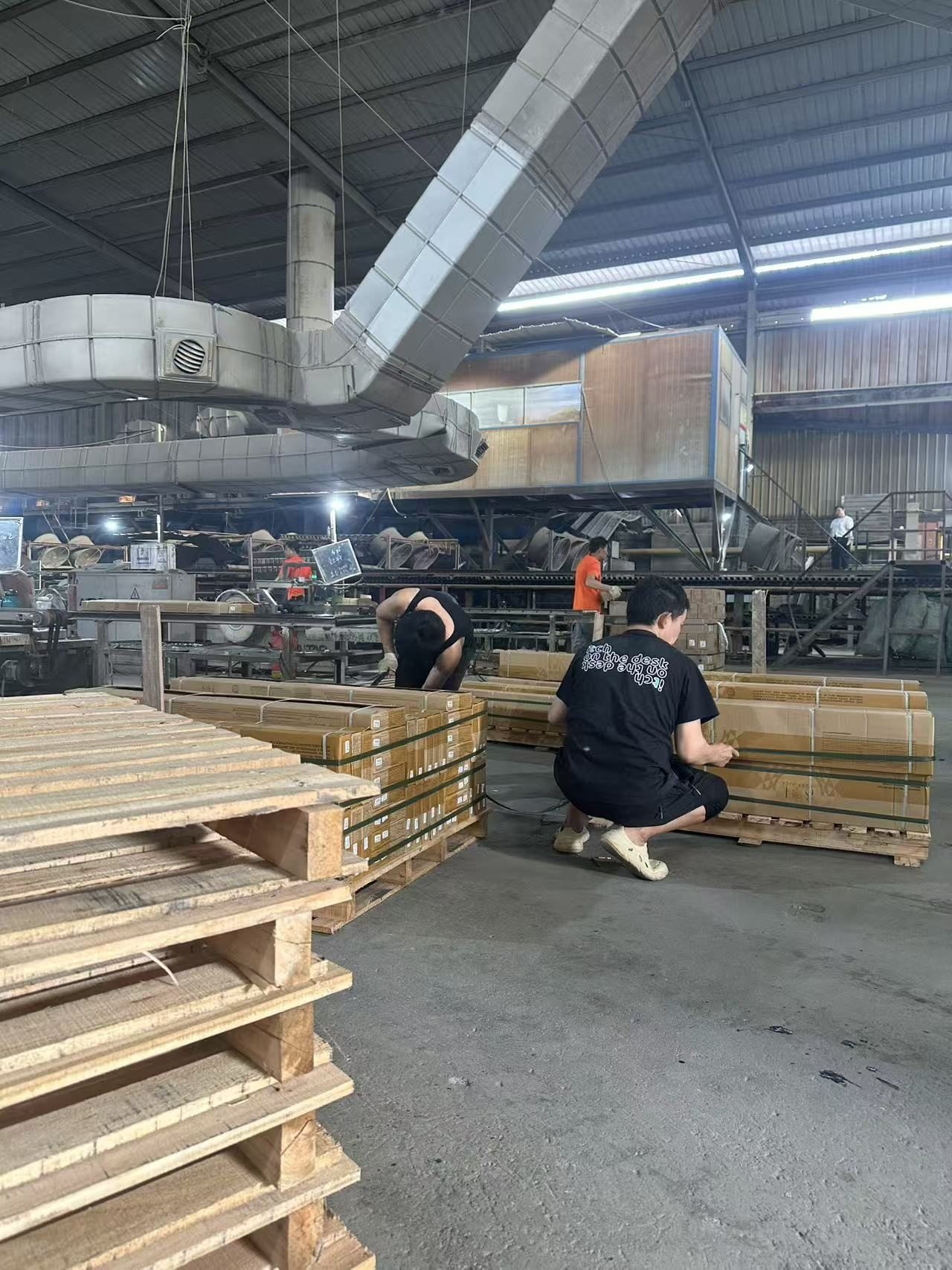YiRong team preparing palletized wood-look tile cartons inside the factory