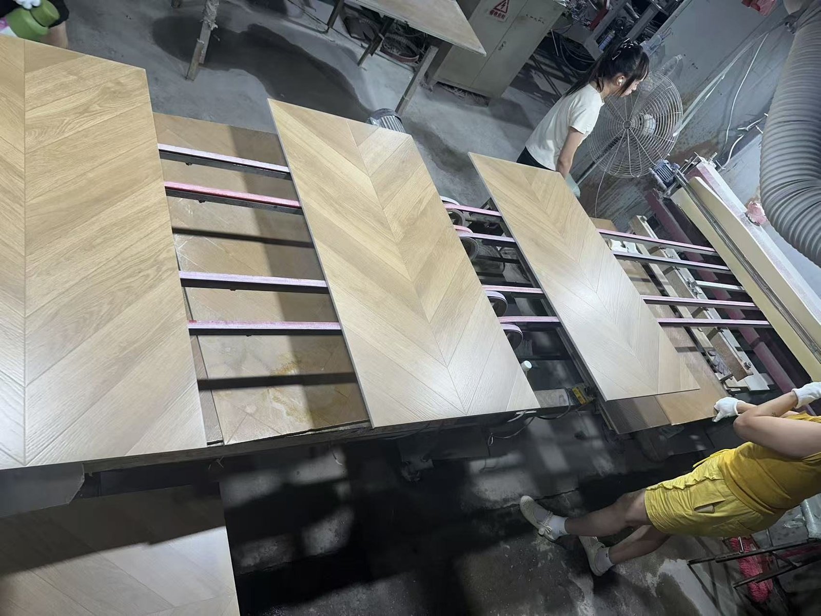 YiRong operators handling wood-look tile during production