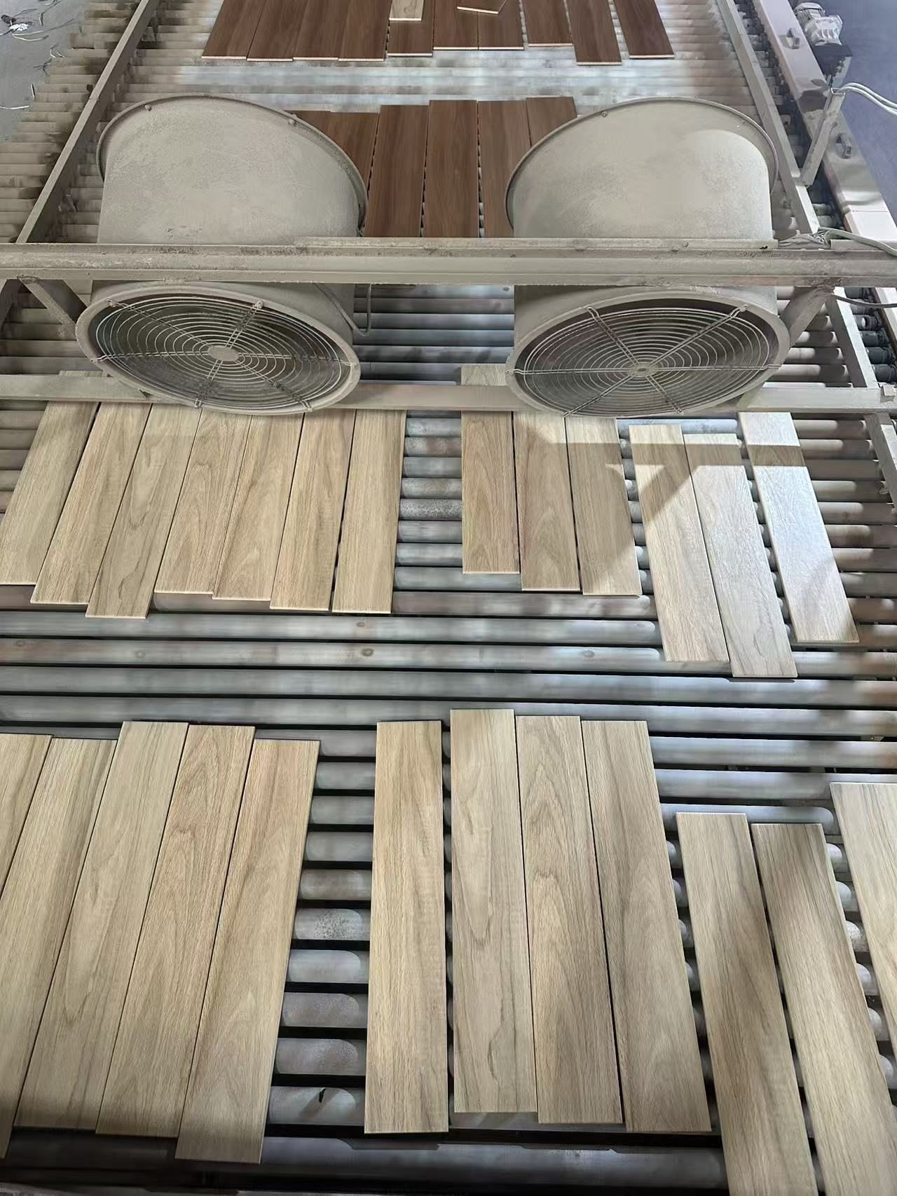 Wood-look tile surfaces moving through production equipment